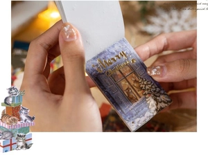 Close-up of vintage Christmas washi sticker booklet with gold foil Merry Christmas text