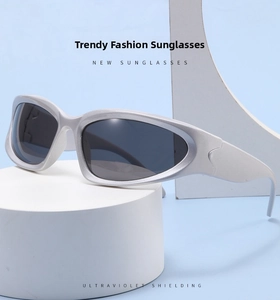 Silver wrap-around Y2K sunglasses with dark UV-shielding lenses on a minimalist display