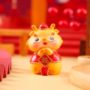 Macro shot of a golden cartoon dragon in red Tang suit holding a Fu character sign