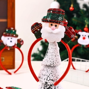 Detail of plush Christmas headband featuring a Santa Claus figure with soft fabric textures
