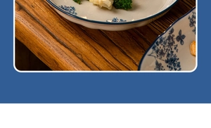 Detail of ceramic plate with traditional blue floral pattern on rustic wooden table