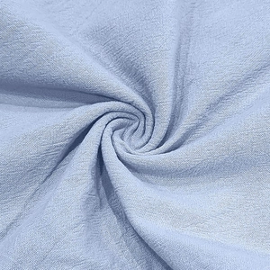 Macro texture of light blue breathable linen fabric with natural slub weave details