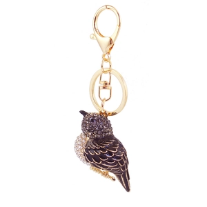 Cute dark owl animal keychain with crystal rhinestones and gold-plated hardware on white