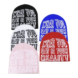 Knitted beanie hats with 'WHAT YOU SAY IS YOUR REALITY' lettering in five colors