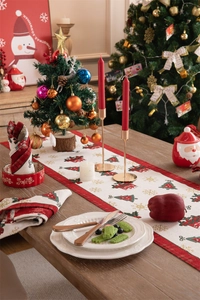 Detailed view of red Christmas table runner with festive tree and snowflake woven patterns