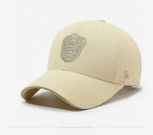 Close-up of beige cotton baseball cap with R shield embroidery and fine twill texture