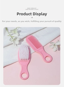 Detailed view of pink baby hair comb and soft bristle brush set for newborn grooming