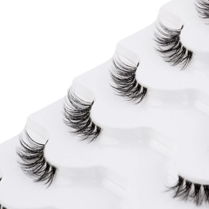 Macro shot of 6 pairs of black half false eyelashes on a white tray for a natural look