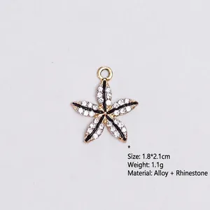 Close-up of star-shaped alloy charm with white rhinestones and black enamel detail