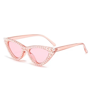 Pink cat-eye sunglasses with white faux pearl embellishments and translucent pink lenses