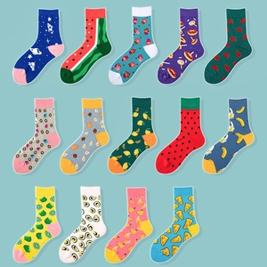 Detailed grid of mid-calf socks featuring vibrant fruit and snack patterns on blue background