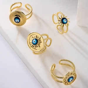 Gold plated evil eye adjustable open rings with colorful enamel on marble background