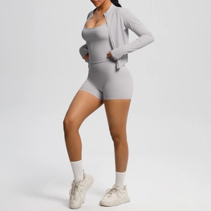 Detailed close-up of three-piece grey yoga set with zipper jacket and high waist shorts