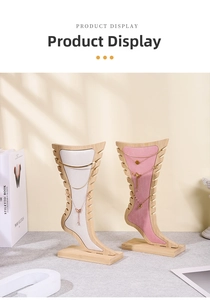 Detailed view of bamboo jewelry display stand with pink and white velvet lining inserts