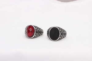 Close-up of vintage viking rings with red and black gemstones and Celtic braid texture