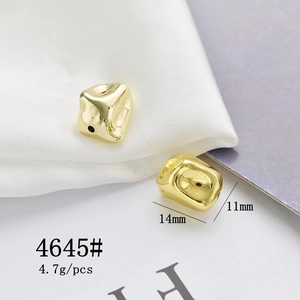Macro shot of 14mm golden irregular cube metal bead with hole for DIY jewelry making