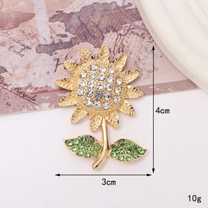 Detail of golden sunflower pin with sparkling crystals including 4cm x 3cm dimensions