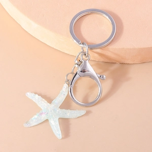 Macro shot of silver starfish keychain with glitter details and lobster clasp
