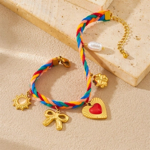 Colorful woven cord bracelet with gold heart bow sun charms and baroque pearl detail