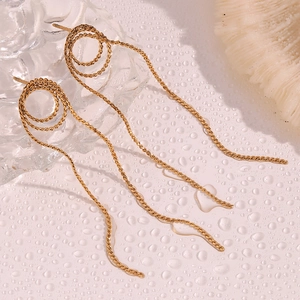 Detail shot of 18K gold plated spiral tassel earrings with long snake chain fringe