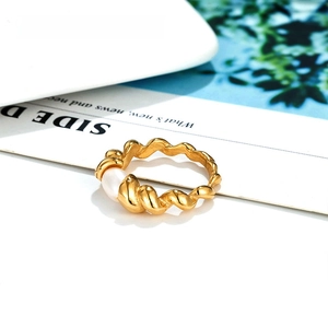 Detail of twisted 14k gold plated band with a natural freshwater pearl in vintage style