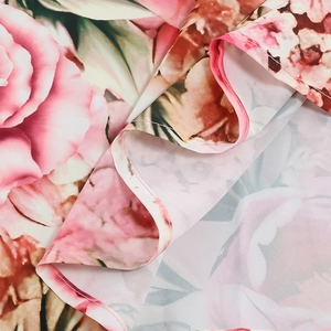 Close-up of pink retro rose floral print fabric with refined stitching on the hem