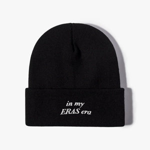 Classic black knit beanie featuring white In My Eras Era embroidery on a plain white backdrop