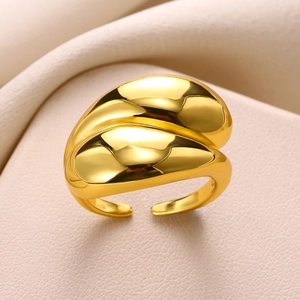 Macro shot of polished gold-plated geometric water drop ring with elegant curved layers