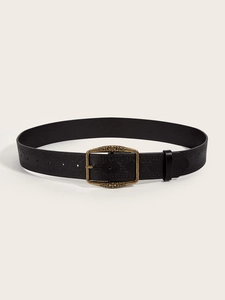 Detailed close-up of retro black leather belt with bronze buckle and embossed vine texture