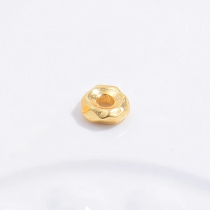 Macro shot of hexagonal gold plated S925 sterling silver spacer beads for DIY jewelry