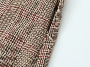 Macro detail of houndstooth jacket fabric with premium invisible zipper closure