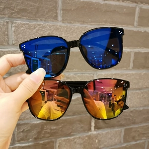 Detail of children's oversized sunglasses with colorful mirror lenses and frame studs