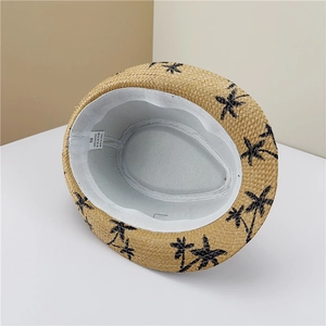 Detail view of the breathable straw hat inner sweatband and 100% paper material label