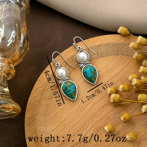 Detailed size view of vintage boho earrings with white bead and blue waterdrop stone