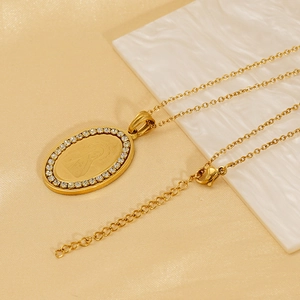 Elegant gold oval pendant necklace with sparkling rhinestones and religious portrait