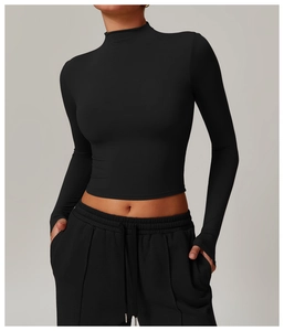 Detailed view of black slim fit crop top featuring functional thumb holes on the cuffs