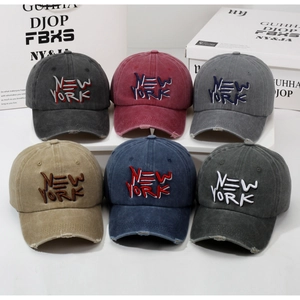 Multiple colors of washed cotton baseball caps with New York embroidery and distressed edges