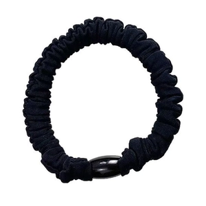 Elastic black fabric scrunchie with glossy oval bead detail on white background