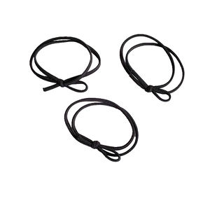 Detailed view of three black high-elasticity hair ties with simple knotted design