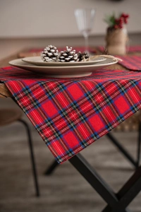 Close-up of red plaid placemat with classic Scottish tartan weave on wooden table