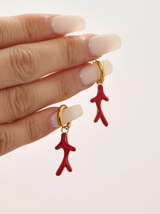 Macro shot of red coral branch drop earrings with 18k gold plated metal rings