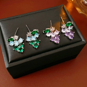 Detailed view of grape-shaped stud earrings with zircon crystals and colorful stones