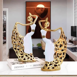 Pair of abstract ceramic ballerina figurines with gold plating and white镂空 details