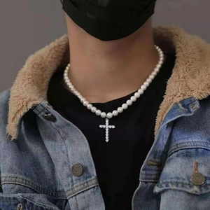 Men's vintage pearl necklace featuring a silver rhinestone cross pendant on grey background