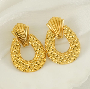 Detail of 18K gold-plated earrings with fan-shaped heads and textured diamond-patterned hoops