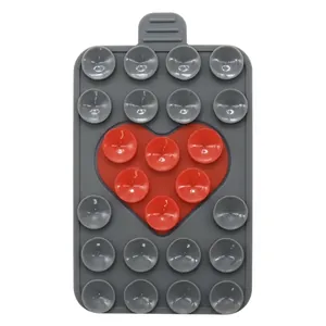 Detail view of double-sided silicone heart suction phone mount with 21 suction cups