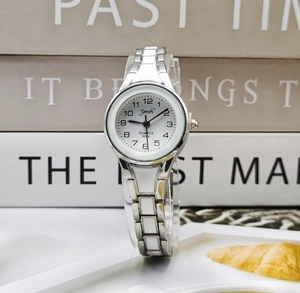 Detailed close-up of white quartz watch face with silver metal and ceramic link bracelet