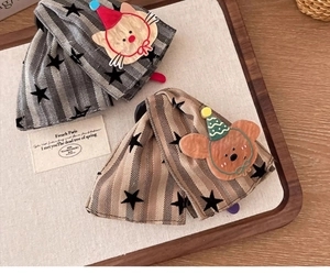 Detail of star-patterned fabric hair claws featuring grey cat and brown bear characters