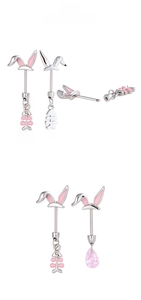 Detailed view of silver titanium steel rabbit ear cartilage studs with pink enamel finish
