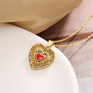 Detailed shot of gold heart necklace with red enamel and colorful crystal accents